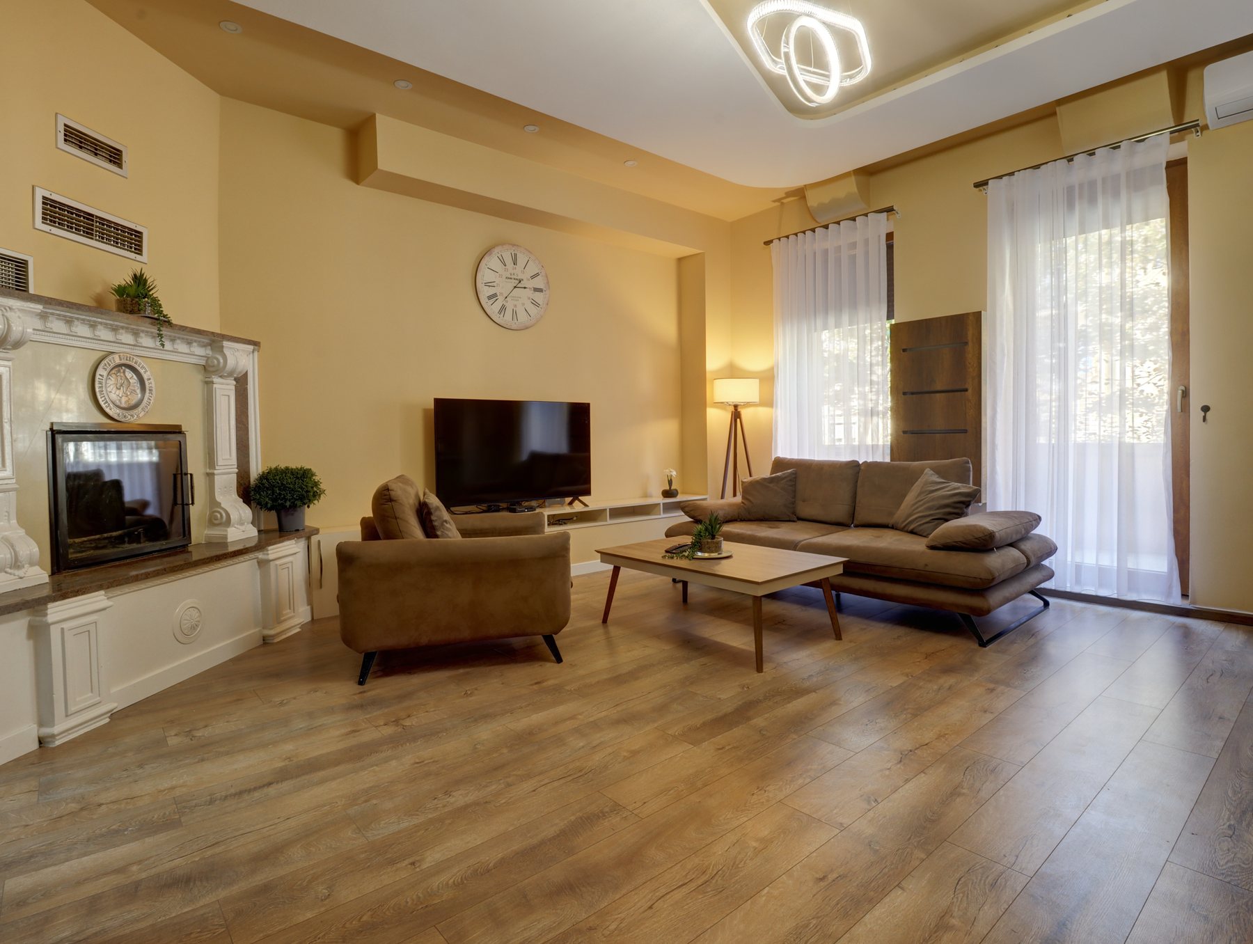 Suite with Balcony living room with sofa and TV